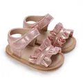Detailed view of pink sparkly baby girl sandals with ruffles and soft soles walking shoes. - Pink