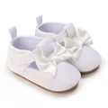 Macro detail of white infant soft sole pre-walking shoes with delicate satin bow - White