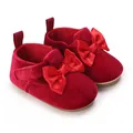 Detail of red velvet baby walking shoes with satin bow for infants aged 0-1 year - Red