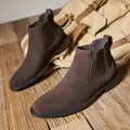 Classic men's brown suede Chelsea boots with elastic side panels on rustic wood - 39 / Coffee