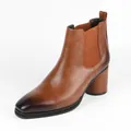 Detailed side view of a stylish brown leather Chelsea boot featuring a chunky block heel. - Tan