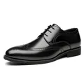 Classic black leather Brogue shoes with elegant wingtip carving on white background. - Black