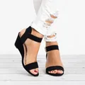 Detailed view of women's black wedge sandals featuring an adjustable ankle buckle strap. - 35 / Black