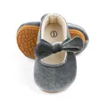 Detailed view of grey velvet baby girl shoes featuring a cute bow and anti-slip rubber sole - Gray
