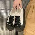 Sneaker chunky con plateau, lacci spessi e dettagli a fiocco neri - Bianco e nero