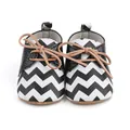 Detail view of baby pre-walker shoes with black and white chevron pattern and tan laces - Insole Length 11cm / 2193 Zigzag Pattern / Black