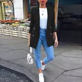 Woman wearing elegant black mid-length blazer with jeans in urban street setting - S / Tops / Black