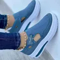 Close-up of blue breathable mesh platform sneakers with cut-out design and strap. - Blue