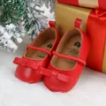 Close-up of red baby princess shoes with a bow for Christmas on a white fur background. - Red D (Bow Style)