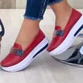 Detail view of stylish women's red platform loafers featuring white soles and buckle decor - 38 / Red