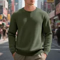 Detailed view of men's olive green waffle knit sweatshirt in urban street setting - Army Green