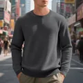Close-up of men's grey waffle knit crewneck sweater with casual textured pattern. - Dark Gray