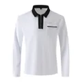 Detail of a white long-sleeve polo shirt with a black contrast collar and half-zipper. - S / Tops / White with Black Trim