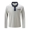 Detail shot of men's grey long sleeve polo shirt with navy contrast collar and half zip - Gray with Navy Collar