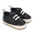 Detailed view of navy blue baby sneakers with white laces and soft anti-slip soles. - Black