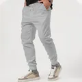 Close-up detail of men's grey casual joggers featuring a drawstring waist and elastic cuffs - S / Bottoms / Light Gray