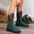 Close-up of green and brown mid-calf knight boots with side zipper and chunky sole - Green