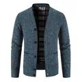 Close-up of men's blue V-neck knit cardigan with plaid lining and textured finish. - Blue Gray