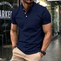 Detail view of navy blue men's polo shirt with chest pocket and stylish buttoned V-neck - S / Tops / Navy Blue