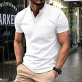 Close-up of white slim fit men's polo shirt with chest pocket and button neck - S / Tops / White