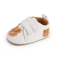 Detailed view of white corduroy baby walking shoes featuring cute brown bear embroidery - Insole Length 11cm / White