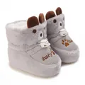 Close-up of grey plush baby booties with fleece lining and cute paw embroidery - Gray