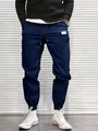 Detailed view of men's navy blue cargo joggers featuring drawstring waist and elastic cuffs - M / Bottoms / Navy Blue