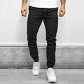Detail shot of men's black cargo joggers with elastic cuffs and drawstring waist - M / Bottoms / Black