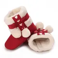 Detailed view of warm red baby winter boots with soft white fleece lining - Red