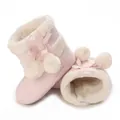 Detail of pink baby winter boots with soft white fleece lining and cute pom-pom bows - Pink