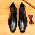 Bottines Chelsea élégantes en cuir noir pour hommes avec bout pointu et boucle latérale. - Noir