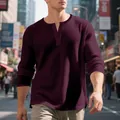 Close-up of a men's burgundy waffle knit Henley shirt showing textured fabric and buttons - S / Tops / Burgundy