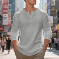 Close-up of a men's grey waffle-knit Henley shirt featuring a classic buttoned placket - Light Gray