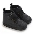 Detailed macro view of black high-top soft-sole baby boots with brogue wingtip design - 11cm / Black