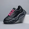 Stylish black chunky dad sneaker for men with vibrant pink laces and visible air cushion - 38 / Black