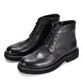 Detailed view of men's black genuine leather Brogue Martin boots with wingtip design - 38 / Black