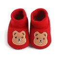 Close-up detail of red baby soft-sole shoes with cute brown bear embroidery pattern - 11cm / Red