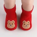 Detailed macro view of red baby indoor shoes with cute cartoon bear embroidery design. - 11cm / Cartoon Bear Style (6127) / Red