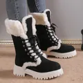 Detail view of black suede snow boots with white faux fur lining and thick platform sole - 36 / Black