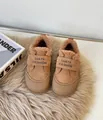 Detail view of warm brown suede kids winter shoes featuring soft plush faux fur lining for winter - Earthy Yellow