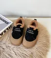 Detailed view of kids' winter sneakers with warm plush lining and Velcro straps - Black
