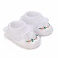 Close-up detail of white baby christening shoes with floral embroidery and lace trim - Inner Length 9cm / K07 White