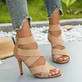 Women's beige high heel sandals with elastic cross straps and back zipper design. - Turmeric