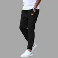 Men's black casual joggers sweatpants with drawstring and leather patch detail for fall - S / Black