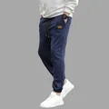 Side view of men's navy blue cargo sweatpants with drawstring and elastic cuffs - S / Navy Blue