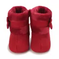 Front view of red infant soft-sole winter boots with plush lining and bow detail - Red