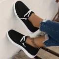 Lightweight black women's canvas loafers featuring white laces and comfortable white sole - Black