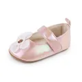 Side view close-up of a pink iridescent baby girl walking shoe with a white flower detail - 11cm / Pink