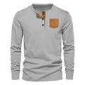 Detail of men's grey ribbed Henley shirt featuring a brown contrast chest pocket. - S / Tops / Light Gray