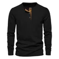 Macro view of the ribbed texture and contrast button placket on black Henley shirt - Black